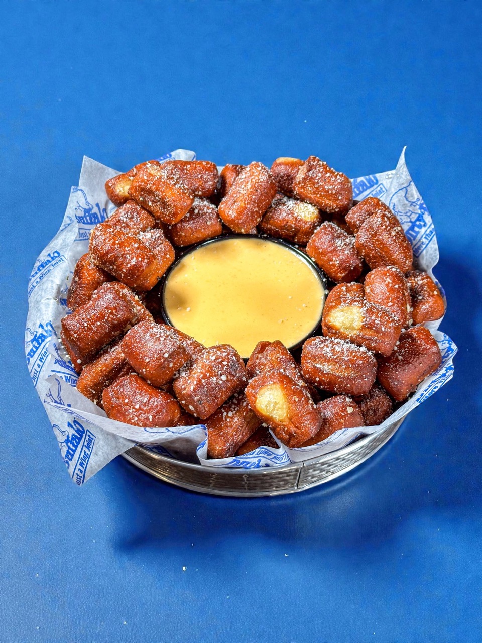 Basket of Dirty Buffalo pretzel bites with beer cheese dip