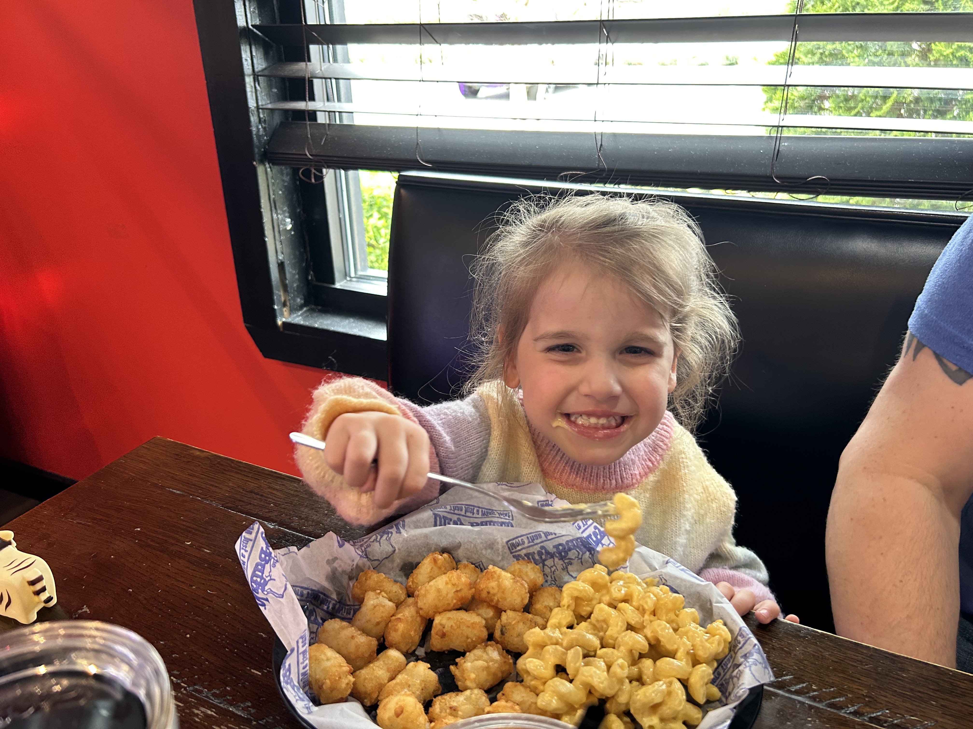 A young guest digging into a plate of food at The Dirty Buffalo Princess Anne