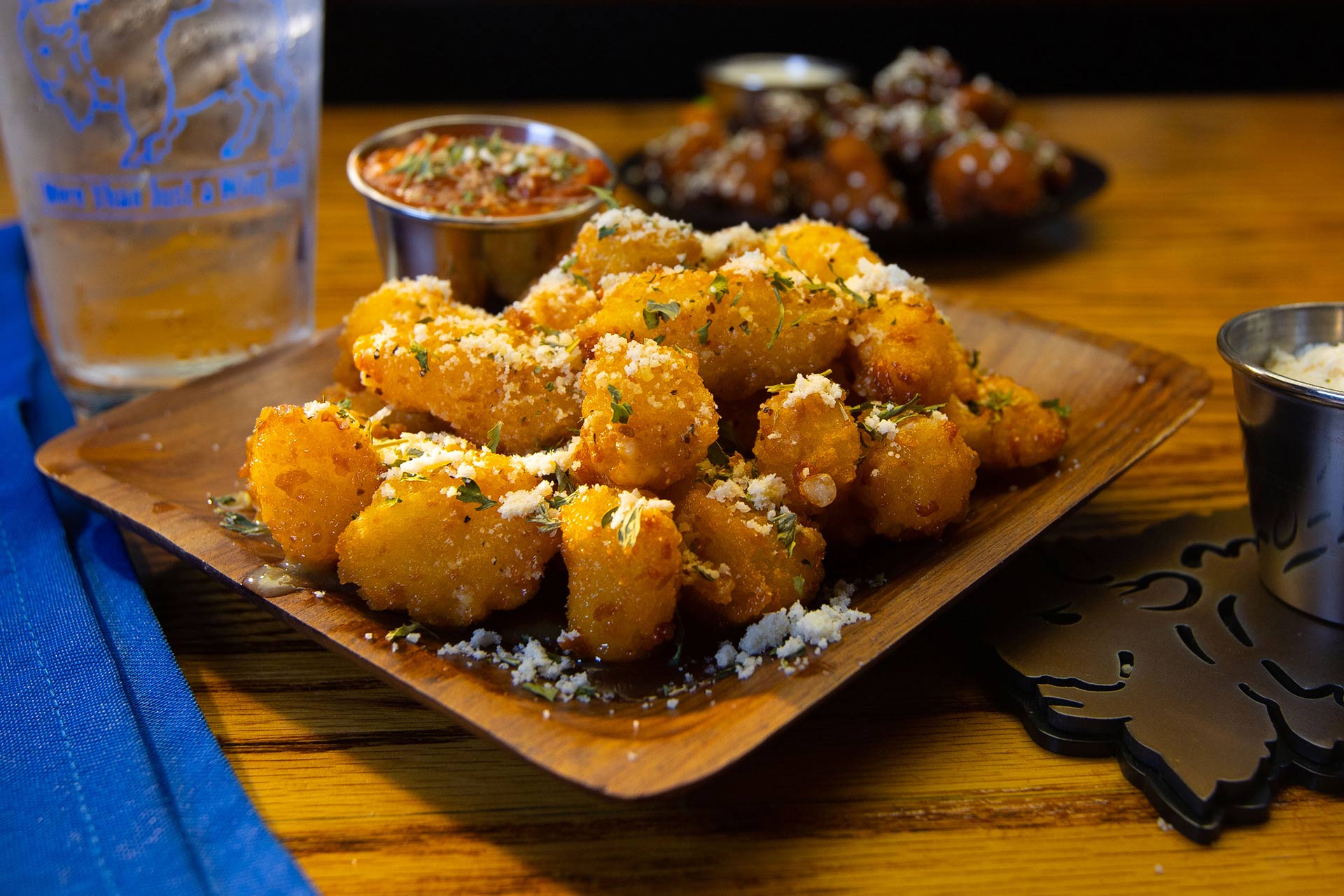 Parmesan pretzel bites dusted with grated parm and parsley, served with marinara
