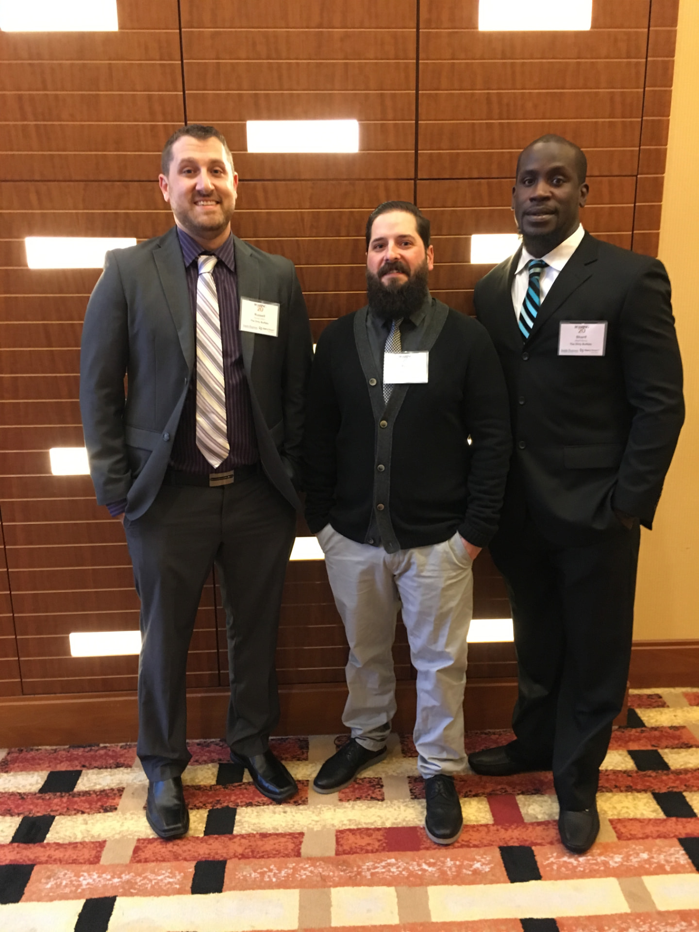 Russ Gilbert with two others in suits at the Inside Business Entrepreneurial Excellence Awards