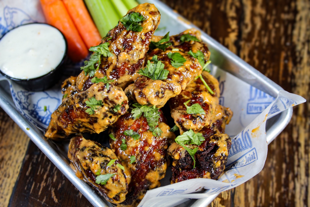 Baja Ranchero wings topped with creamy ranchero sauce and cilantro