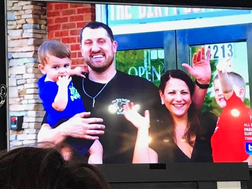 Russ and Steph Gilbert with their kids on screen during Travel Channel's Food Paradise