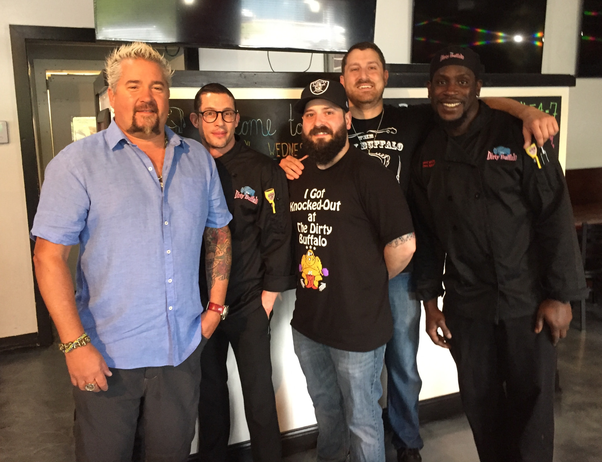 Guy Fieri with The Dirty Buffalo crew during the Diners, Drive-Ins and Dives visit