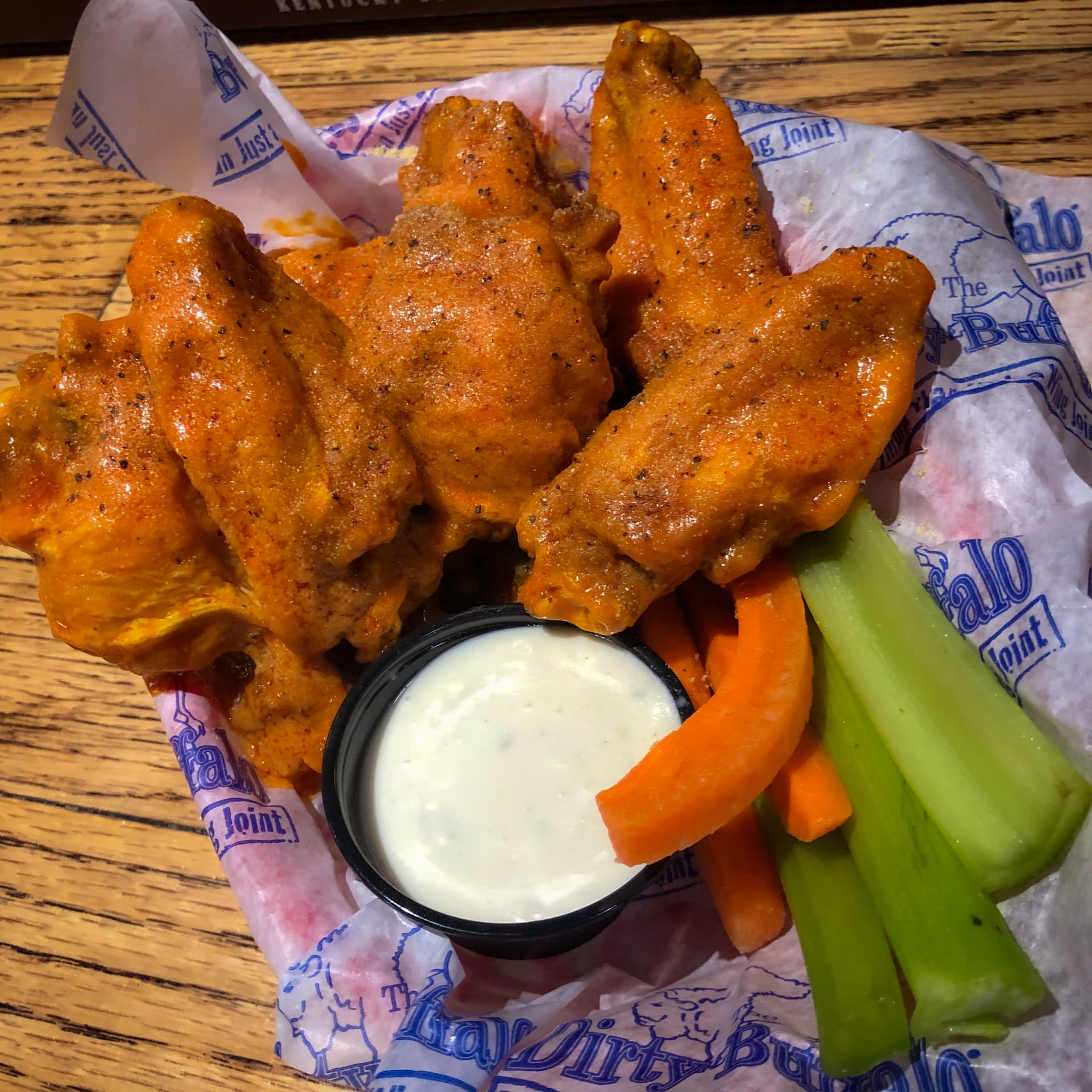 A basket of Tag Team wings — buffalo sauce topped with a dry rub