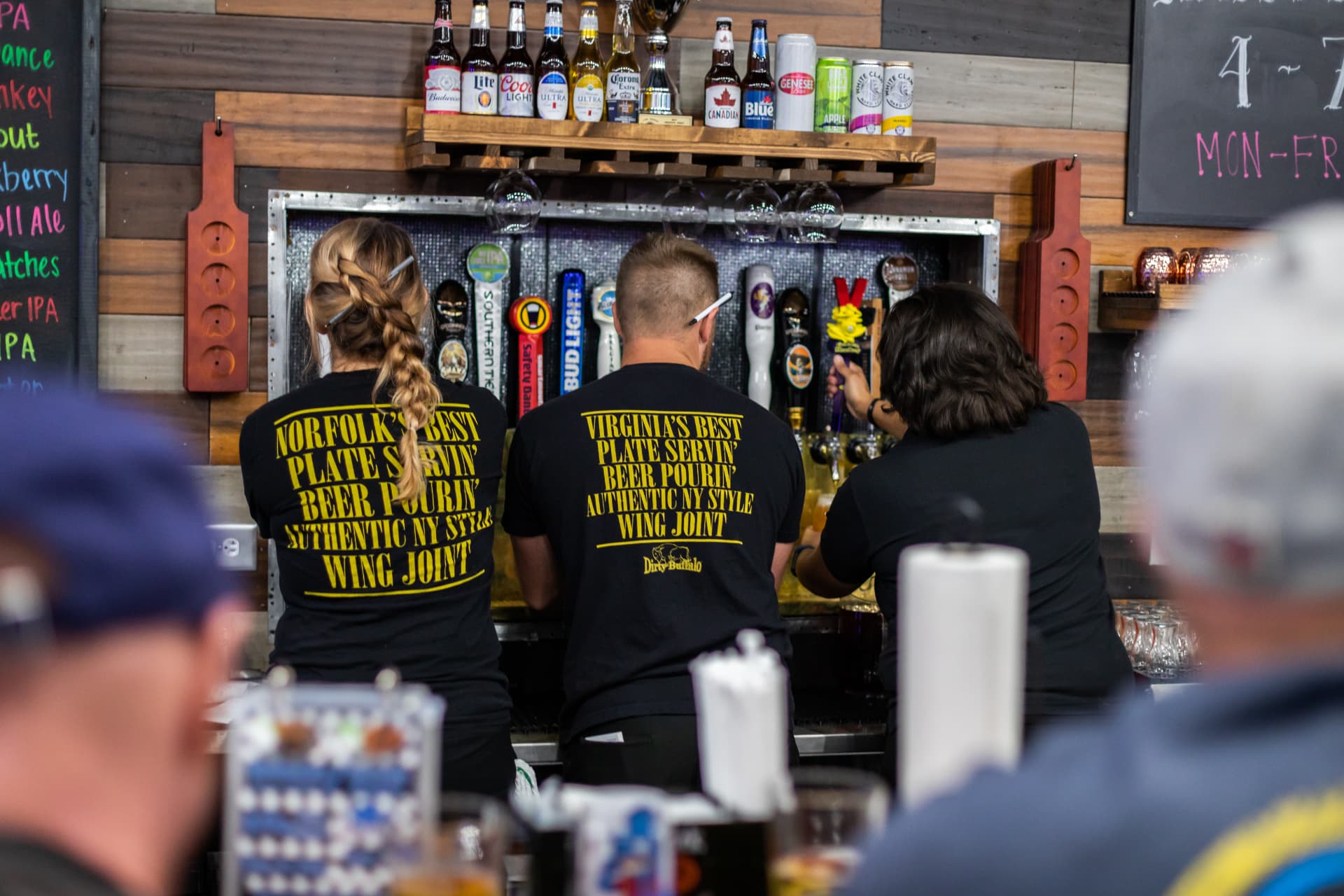Dirty Buffalo bartenders pouring drafts at the tap wall