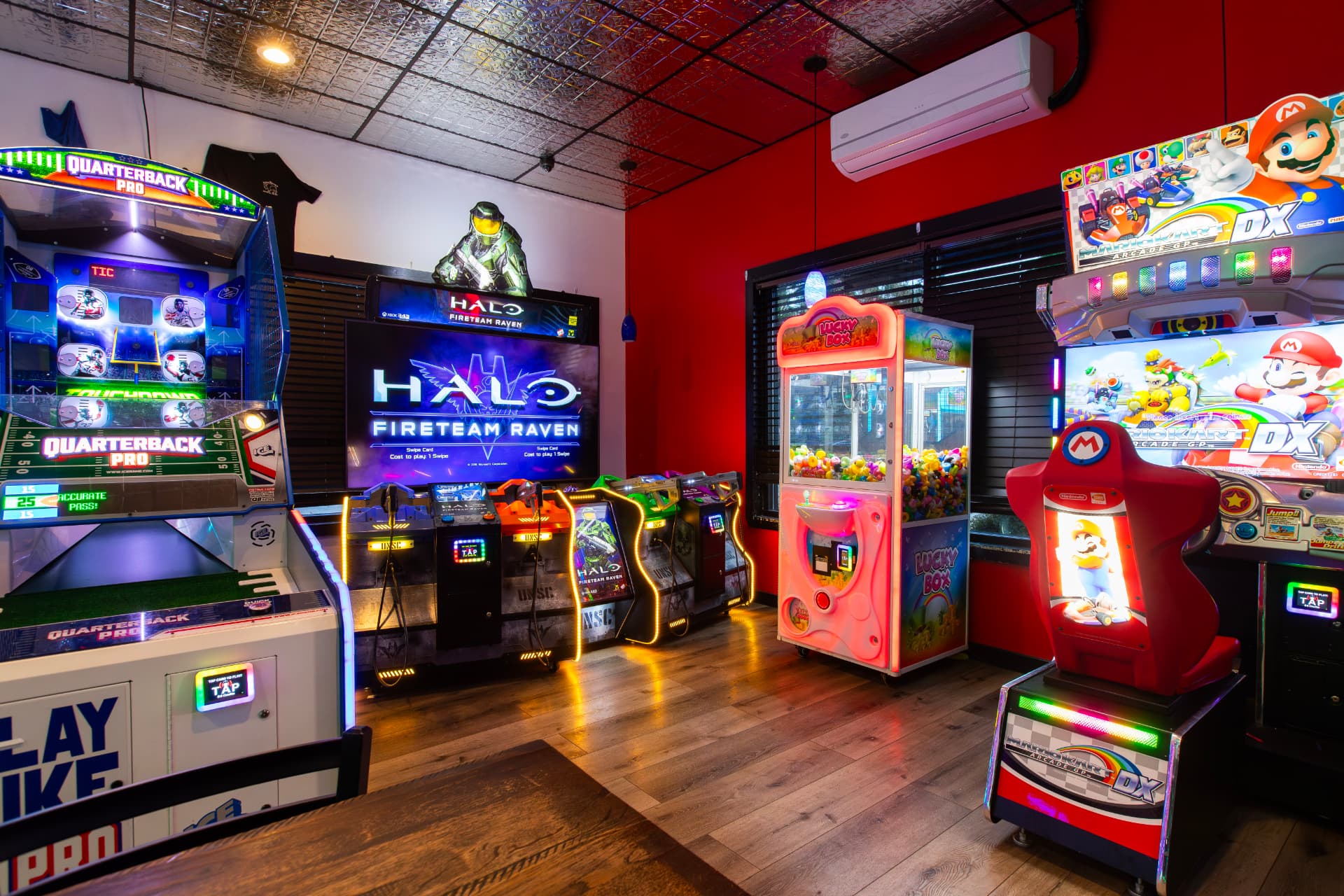 The Princess Anne game room with Quarterback Pro, Halo Fireteam Raven, a claw machine and Mario Kart