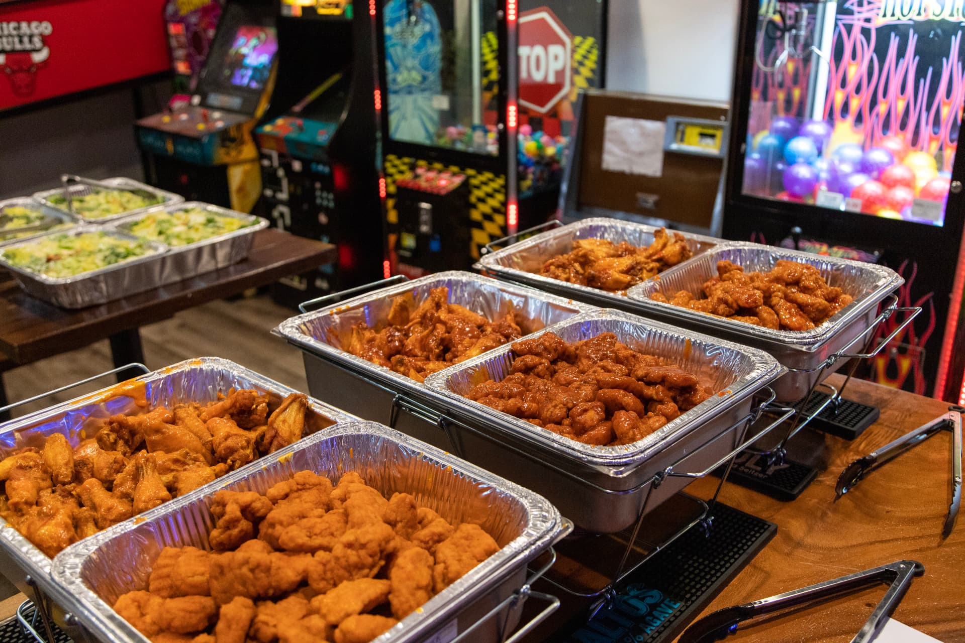 Full Dirty Buffalo catering spread of bone-in wings, boneless wings and salads in chafing trays