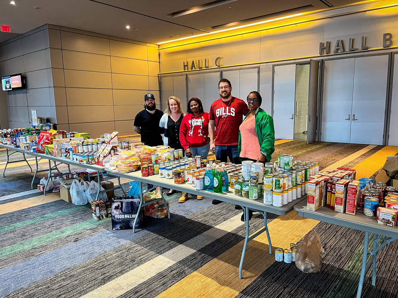 Volunteers with tables of donated groceries at a Hampton Roads food drive