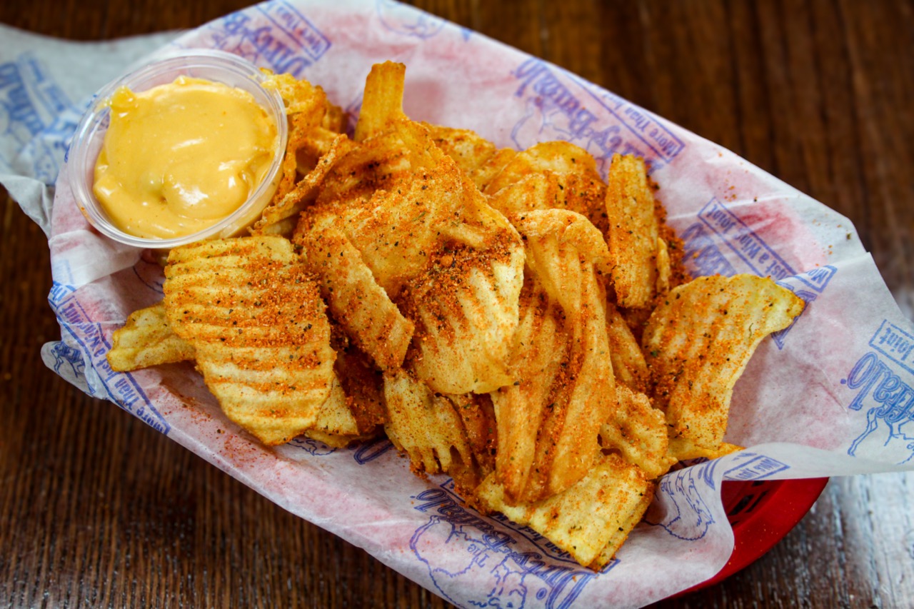 Down 'N Dirty crinkle cut chips tossed in dry rub with a side of cheese sauce