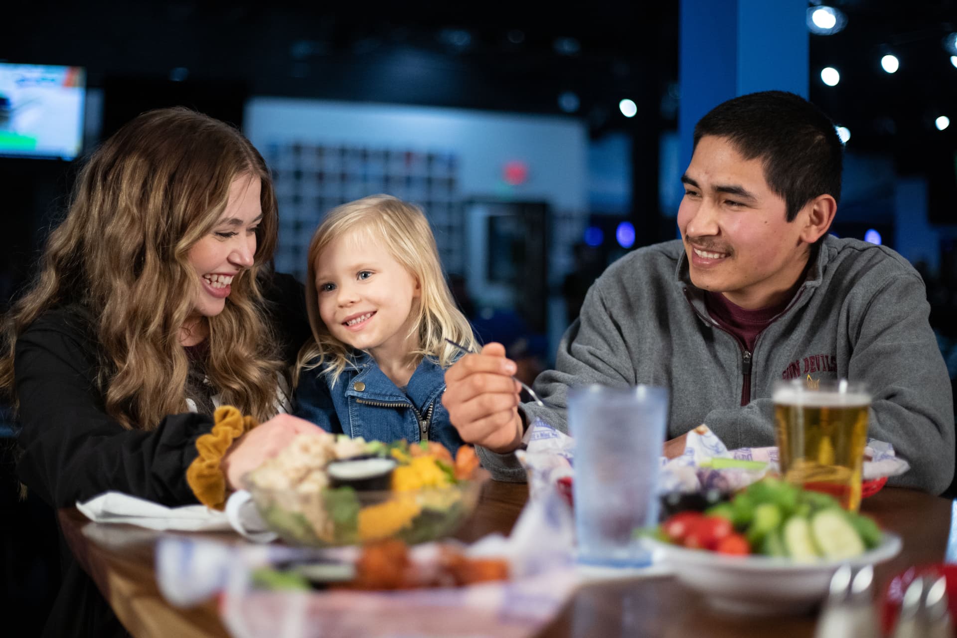 A family sharing wings at The Dirty Buffalo
