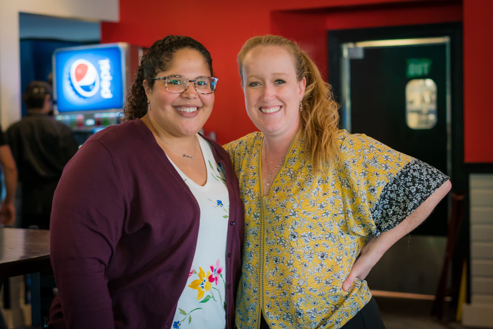 Two Dirty Buffalo managers smiling together inside the restaurant